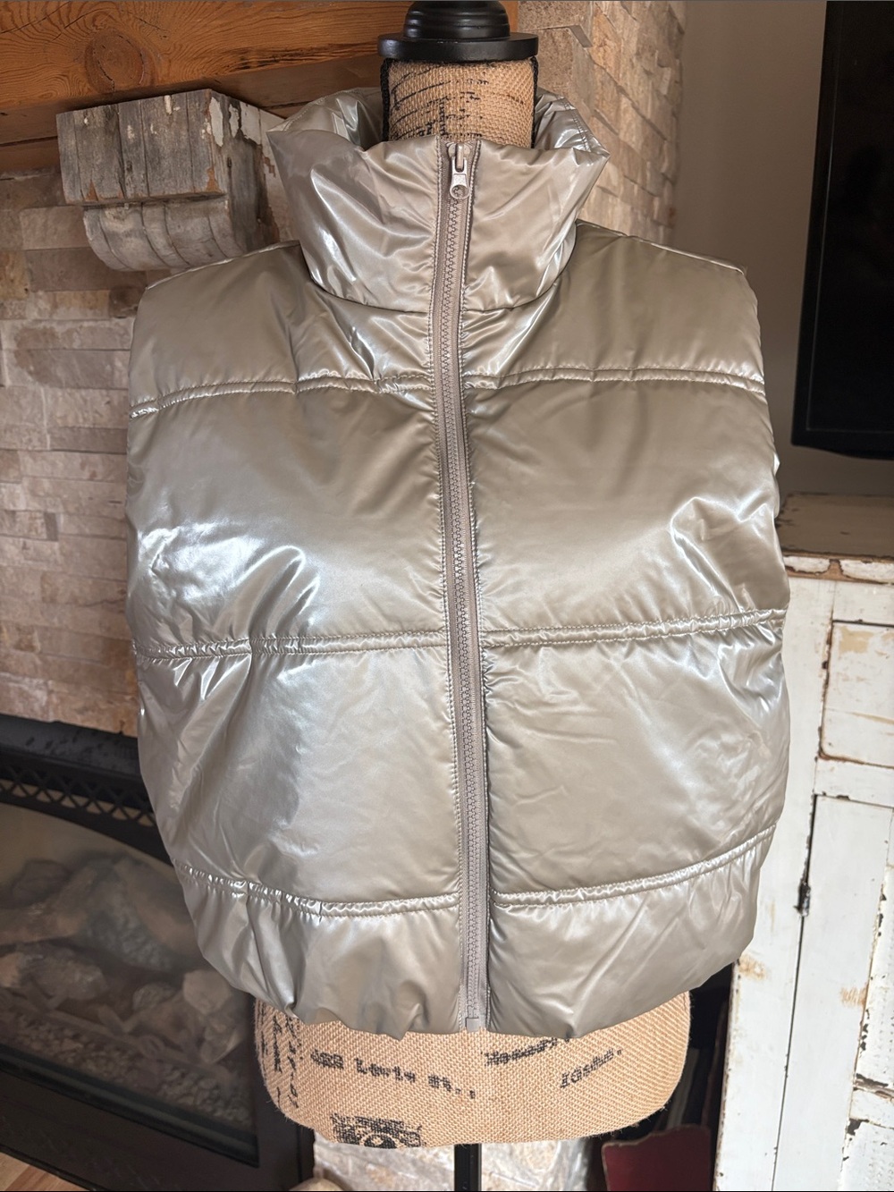 Active USA metallic champagne cropped puffer vest with zip close and pockets.
